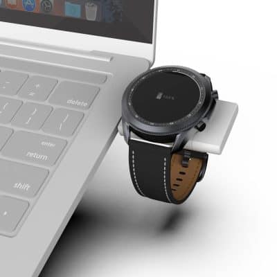 High-quality smartwatch on charging dock next to a sleek laptop, emphasizing modern eye care technology and digital accessories shop.