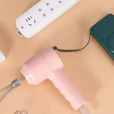 Bright pink handheld mixer with stainless steel beaters, ideal for kitchen use and baking needs. Compact and easy to use for mixing ingredients effortlessly.