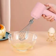 Handheld electric mixer for smoothies and desserts, perfect for home kitchen use, featuring a sleek pink design.
