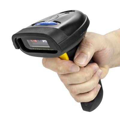 Hand holding a digital eye prescription scanner, used in optical stores like Monalisa for accurate vision testing and lens measurements.