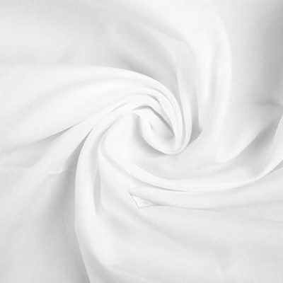 Close-up of a clean, white surgical mask fabric, ideal for medical and health care settings, emphasizing hygiene and safety for eye care and optical purposes.