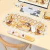 Cute cat bakery-themed desk mat with bread and pastry illustrations, perfect for adding charm and comfort to your workspace with this adorable design.