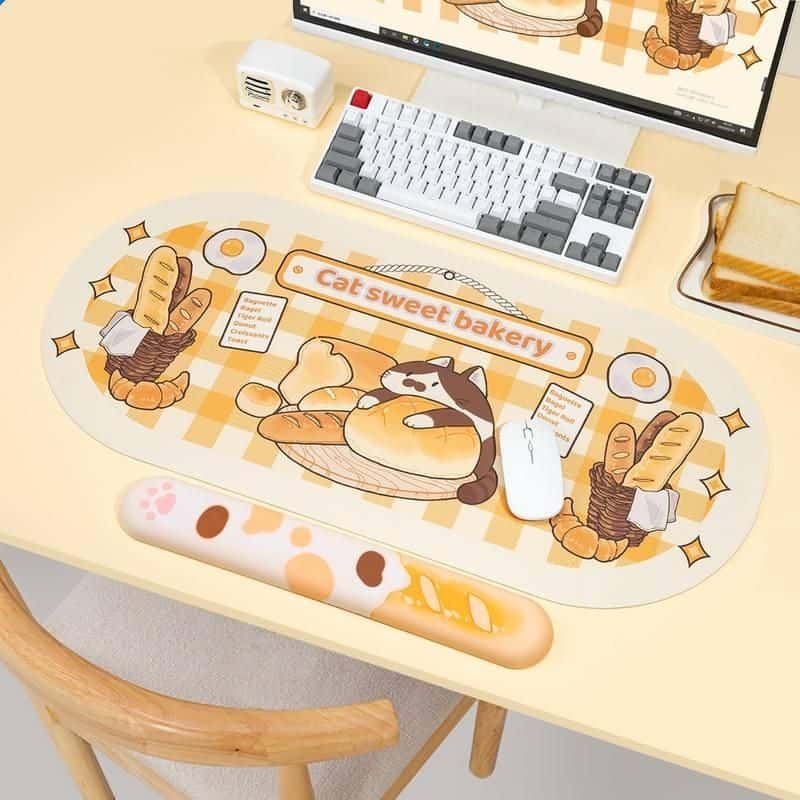 Cute cat bakery-themed desk mat with bread and pastry illustrations, perfect for adding charm and comfort to your workspace with this adorable design.