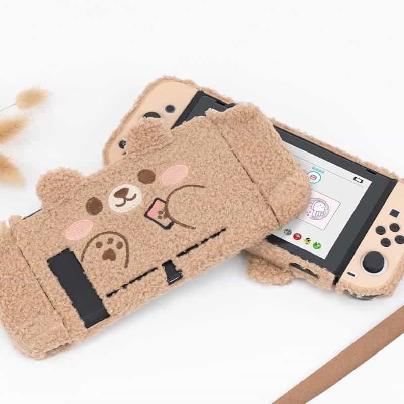 Deluxe beige teddy bear-themed digital device protector for Nintendo Switch or gaming consoles, featuring a plush, cuddly design and cartoon bear face, ideal for kids and gaming enthusiasts.