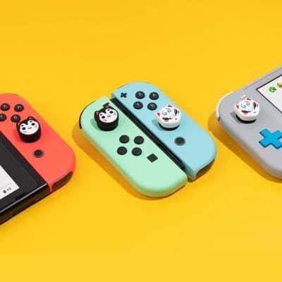Colorful Nintendo Switch Joy-Con controllers with panda and animal-themed grip accessories on vibrant yellow background for gaming enthusiasts.