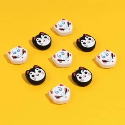 Colorful cat-shaped erasers with playful designs, perfect for school or office supplies, featuring kawaii cat faces in black and white with red accents on a bright yellow background.
