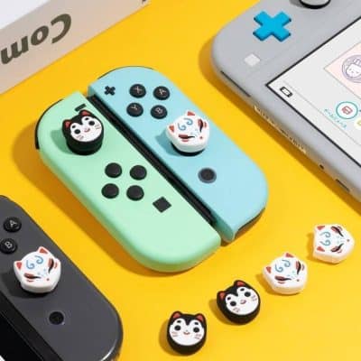 Playful Nintendo Switch Joy-Con controllers with adorable cat and fox face grips, ideal for gamers seeking stylish and comfortable Nintendo accessories.