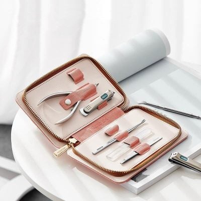 High-quality manicure and pedicure tools in a stylish pink case, perfect for salon or home use. Includes various clippers, scissors, and tools for professional nail care.