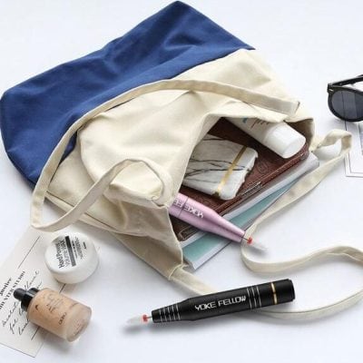 Brightly colored tote bag with daily essentials for glasses and eye care.