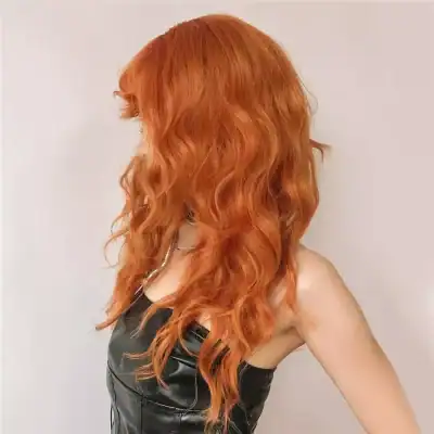 Close-up of stunning vibrant red wavy hair showcasing professional hair coloring and styling services at Monalisa Store.