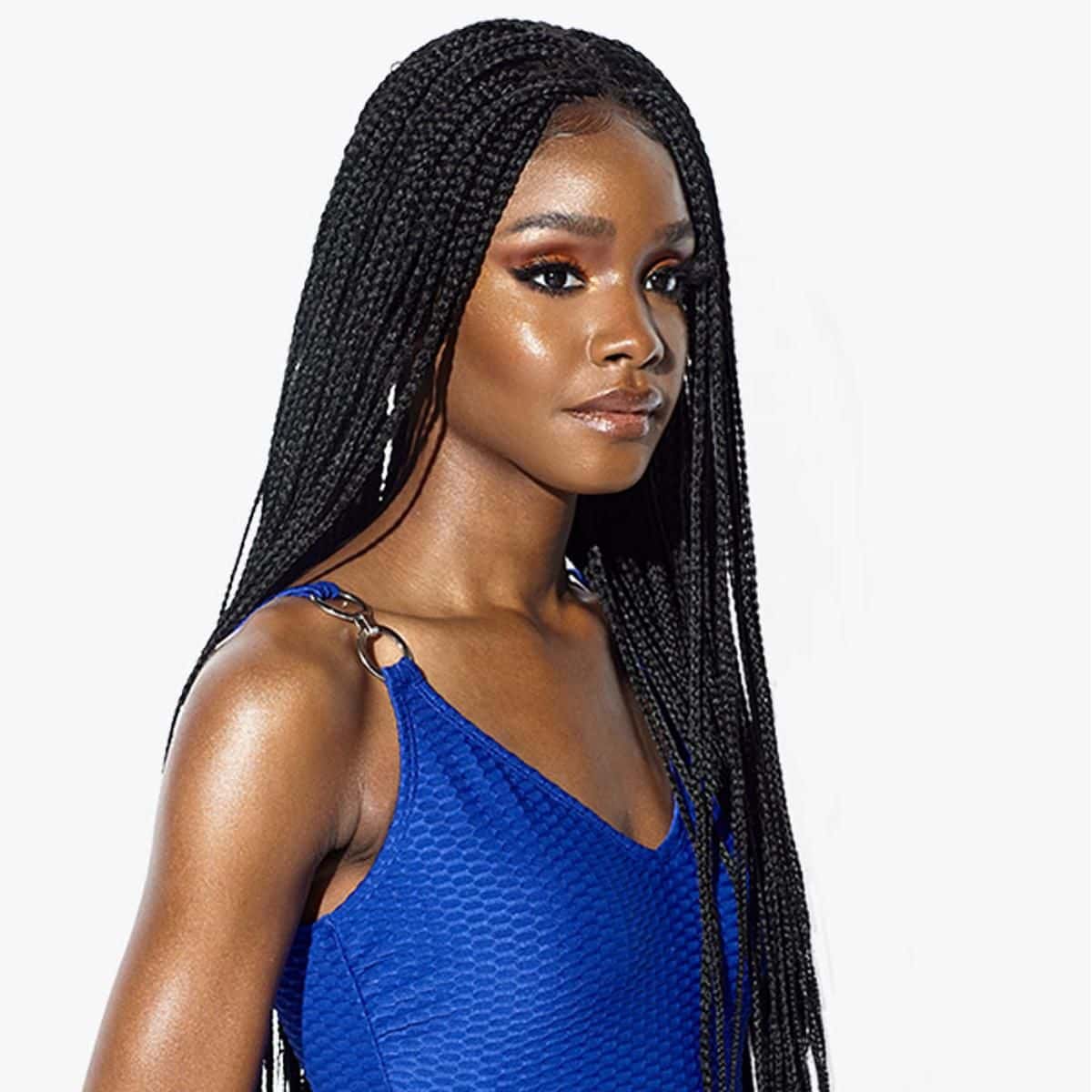 Close-up of a woman with sleek braided hair and sophisticated blue dress, showcasing stylish eyewear options available at Monalisa Medical Store for fashionable and eye health needs.