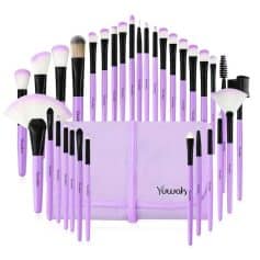 Set of purple and black makeup brushes in a storage pouch, perfect for cosmetics application and beauty routines. Ideal for professional and personal use.