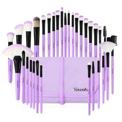 Set of purple and black makeup brushes in a storage pouch, perfect for cosmetics application and beauty routines. Ideal for professional and personal use.