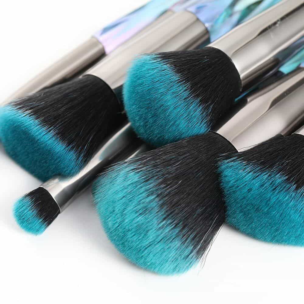 High-quality makeup brushes with blue and black synthetic bristles, ideal for flawless foundation, contouring, and blending. Perfect for professional and personal use at Monalisa Store.
