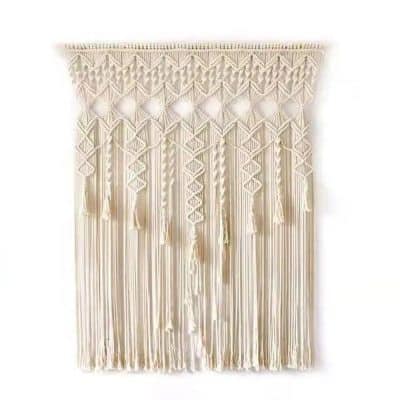 A chic, cream-colored macrame wall decor featuring intricate patterns, tassels, and fringe, perfect for modern bohemian interior styling.