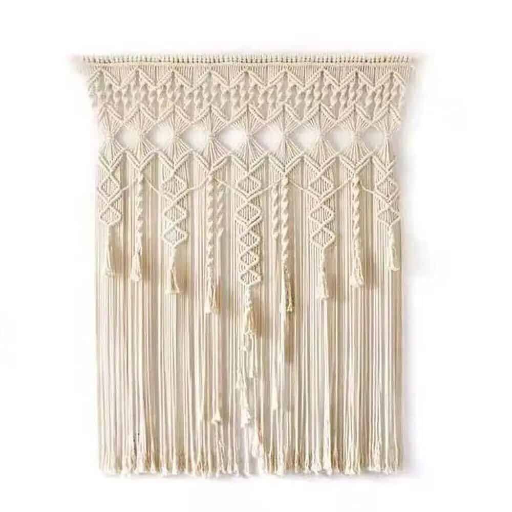 A chic, cream-colored macrame wall decor featuring intricate patterns, tassels, and fringe, perfect for modern bohemian interior styling.