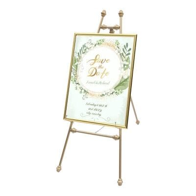 Elegant gold-framed wedding invitation sign on easel, perfect for event decoration and adding a sophisticated touch to special occasions.