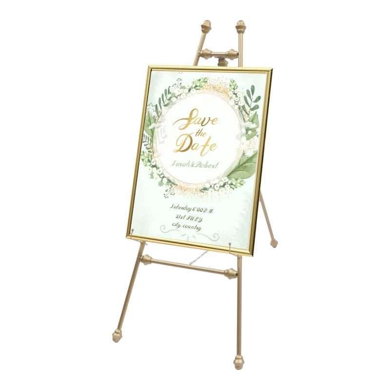 Elegant gold-framed wedding invitation sign on easel, perfect for event decoration and adding a sophisticated touch to special occasions.