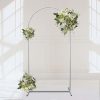 A beautiful white floral arch stand with lush greenery, perfect for wedding ceremonies, photo backdrops, and special event decor.