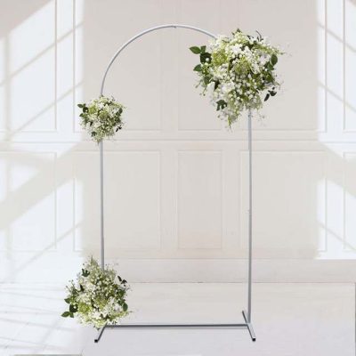 A beautiful white floral arch stand with lush greenery, perfect for wedding ceremonies, photo backdrops, and special event decor.