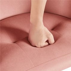 Close-up of a hand pressing into cushioned pink upholstery, emphasizing comfort and support in medical and aesthetic environments.