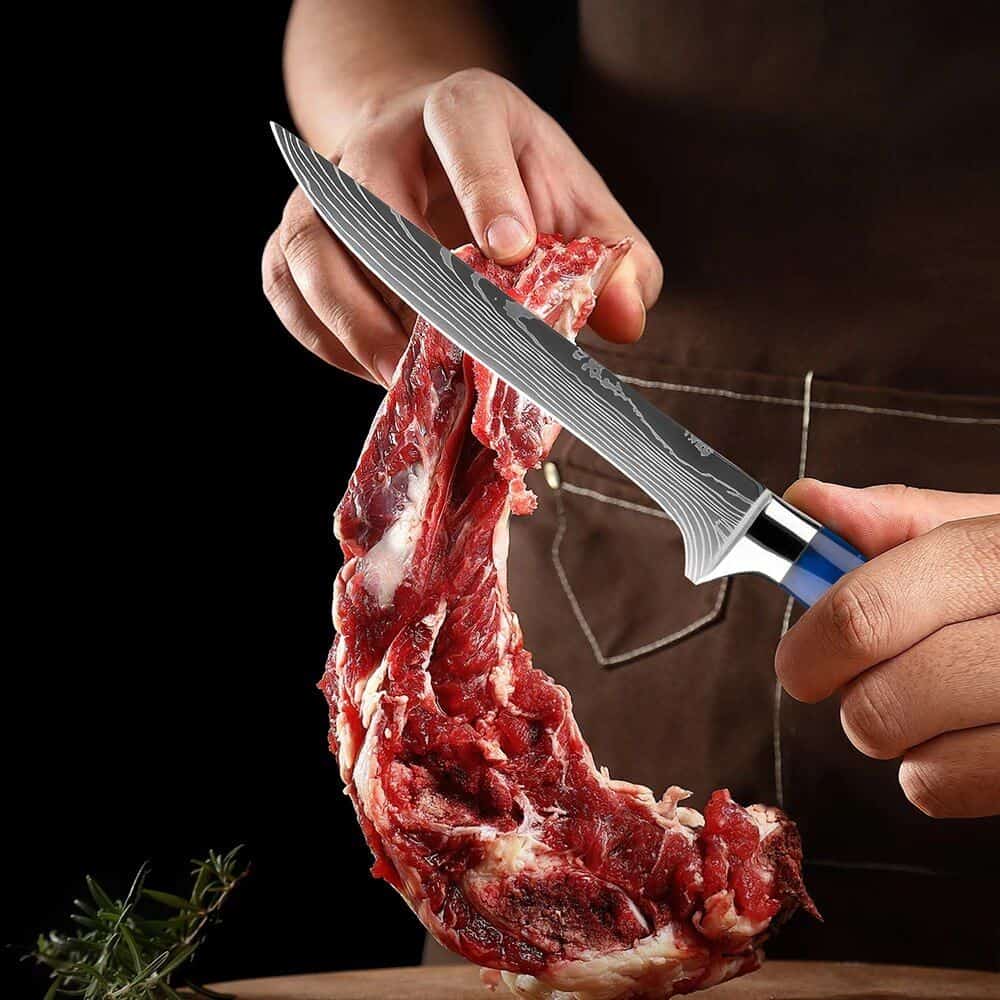 High-quality kitchen steak knife on raw meat.