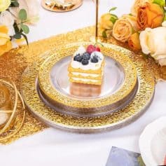 Elegant cake slice with whipped cream and fresh berries on a luxurious gold and silver platter, perfect for special celebrations and elegant gatherings.
