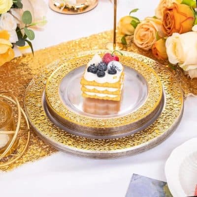 Elegant cake slice with whipped cream and fresh berries on a luxurious gold and silver platter, perfect for special celebrations and elegant gatherings.