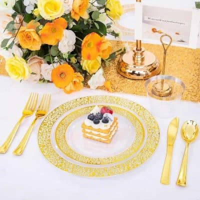 Luxurious table setup featuring gold-handled cutlery, a decorative floral arrangement, and a stylish centerpiece for weddings or special events.