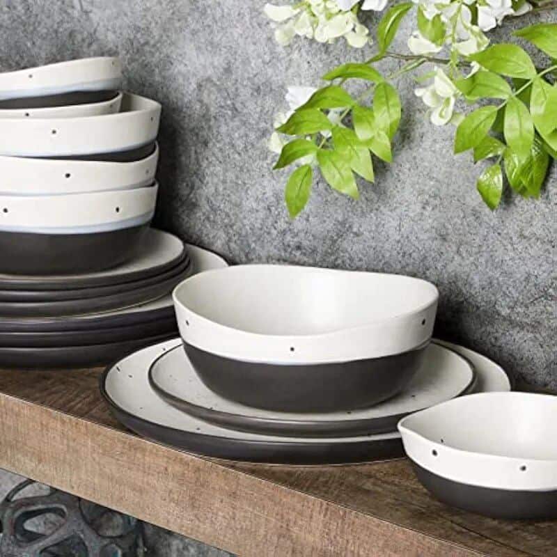 Stylish black and white ceramic bowls and plates for modern table settings, perfect for restaurants, cafes, and home use. Durable and trendy design.