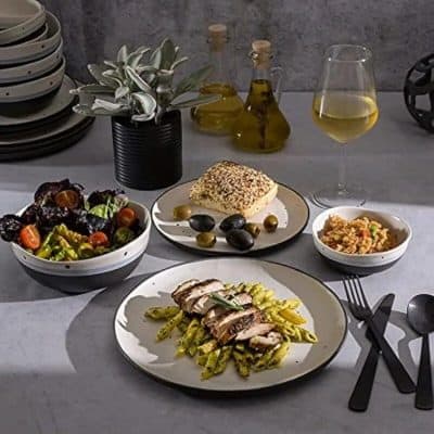 Comfortable dining with healthy Mediterranean cuisine, fresh salad, grilled chicken, rice, and wine.