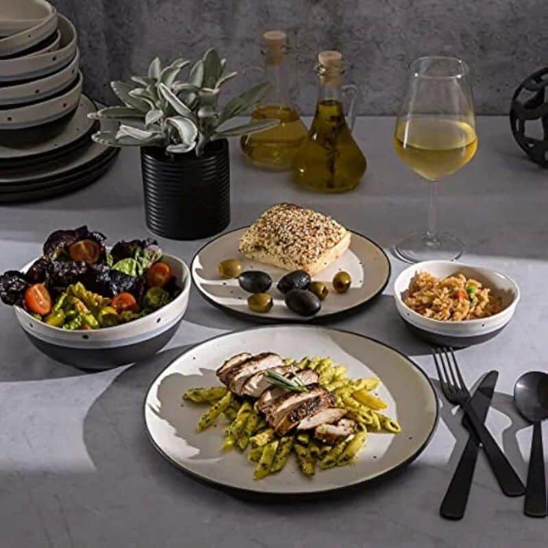 Comfortable dining with healthy Mediterranean cuisine, fresh salad, grilled chicken, rice, and wine.