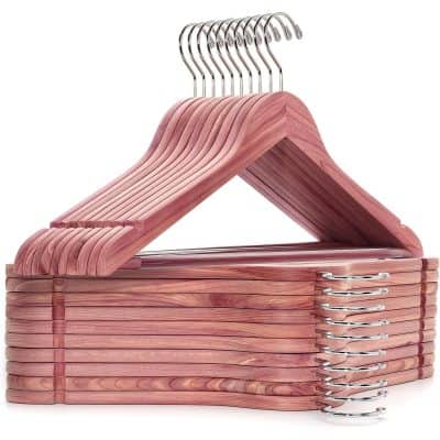 A stack of pink wooden hangers with metal hooks, perfect for organizing glasses or accessories in an optometry or optical store setting.