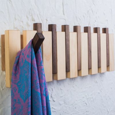 Stylish wooden hook rack for sunglasses and eyeglasses at Monalisa Medical Store, featuring trendy eyewear accessories in a modern, minimalistic setting.
