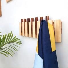 Stylish wooden coat rack with a colorful scarf hanging, perfect for optometry shop or eyewear store display.