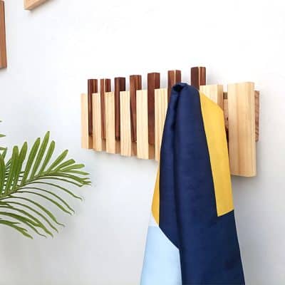 Stylish wooden coat rack with a colorful scarf hanging, perfect for optometry shop or eyewear store display.