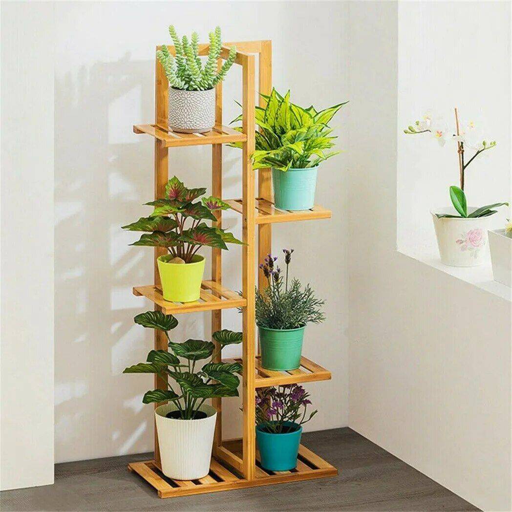 Decorative wooden plant stand with colorful pots for indoor plants, perfect for enhancing home or office aesthetics and supporting healthy plant growth.