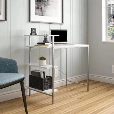 Comfortable workspace with sleek white desk and multi-tier shelf for keeping office essentials organized. Bright lighting from window, ideal for a home office, studying, or telecommuting environment.