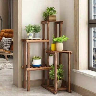 A stylish wooden plant stand with multiple tiers showcasing vibrant indoor plants, perfect for a contemporary home office or living room.