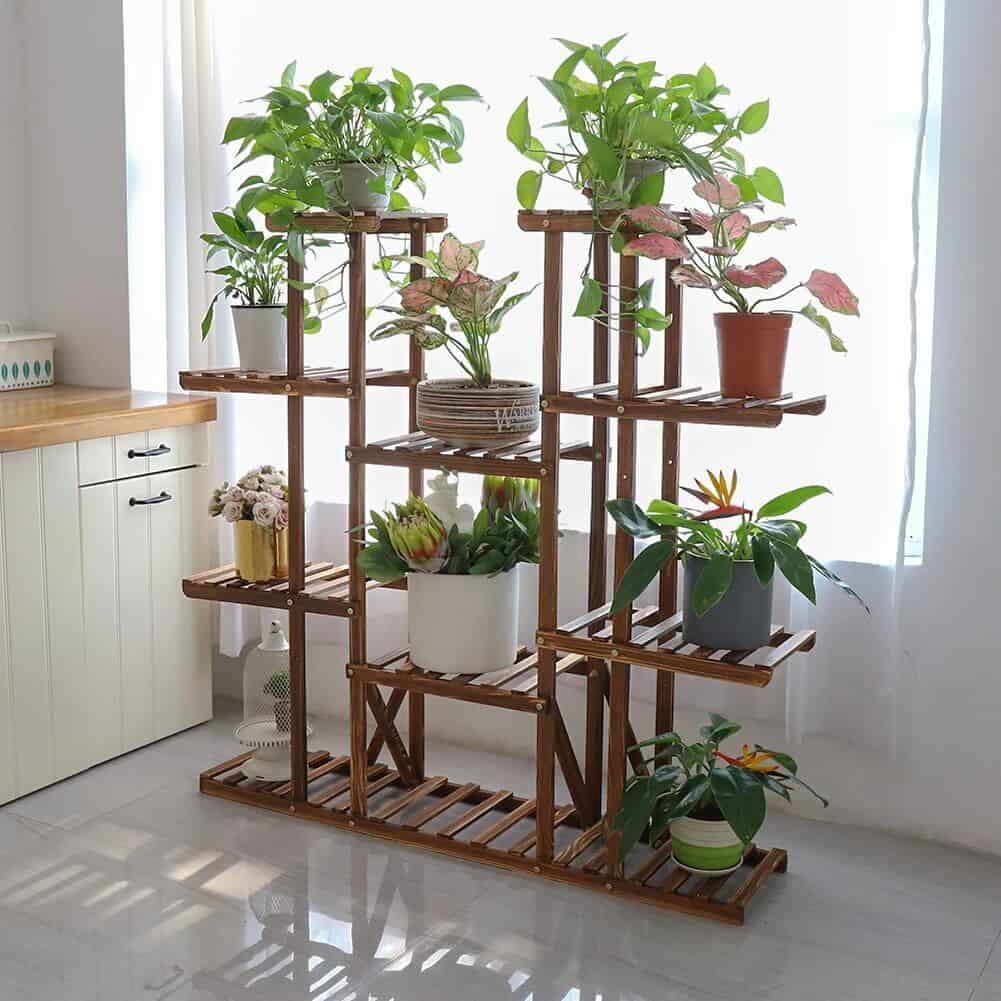 Bright indoor plant stand with multiple tiers, showcasing lush green and flowering houseplants for stylish interior decoration.