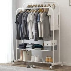 A modern white clothing rack showcasing neatly hung casual shirts, pants, and shoes, perfect for wardrobes or retail stores.