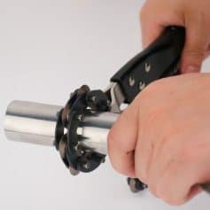 Close-up of handheld tuning device used for precise optical lens adjustments in eye care and optometry clinics.