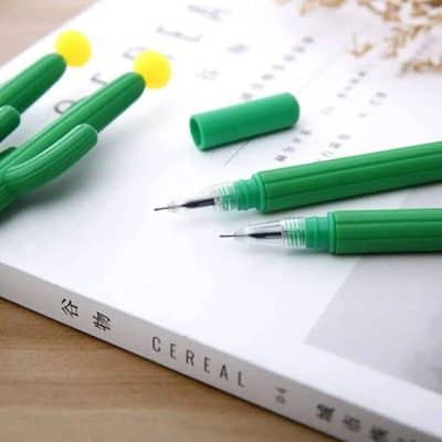 Images of green pen set with removable caps, perfect for office or art projects, displayed on paper. Great for professional, academic, or creative use, emphasizing quality and comfort.