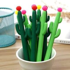 Bright green cactus-shaped pens with colorful flower tops for desk organization and decor. Perfect for adding fun and functionality to your workspace or study area.