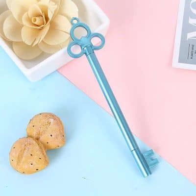 Cute blue eye-shaped eyelash curler, perfect for enhancing eye beauty and makeup routines, featured alongside cookies and decorative flowers for a stylish beauty accessory display.