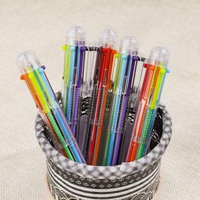 Vibrant gel pens in assorted colors arranged in a black and white patterned container, perfect for enhancing your stationery collection at Monalisa Medical Store.
