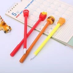 Colorful pens with ice cream and burger designs on a planner, perfect for organizing daily schedules and note-taking, ideal for students and professionals.