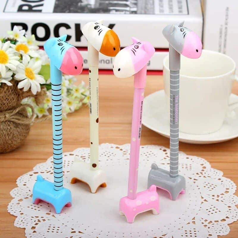 Adorable giraffe-shaped pens in pastel colors, perfect for kids or cute stationery collections. Features striped and dotted designs with sturdy bases for easy writing.