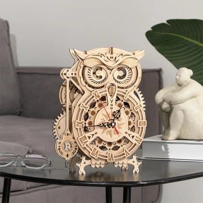 Elegant wooden owl-shaped clock with intricate gears and Roman numerals, perfect for home decor. Adds a touch of sophistication and functionality to your living space.