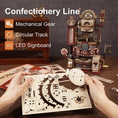 High-quality wooden craft kit for making a confectionery-themed mechanical model with LED lights, circular tracks, and detailed mechanical gears.